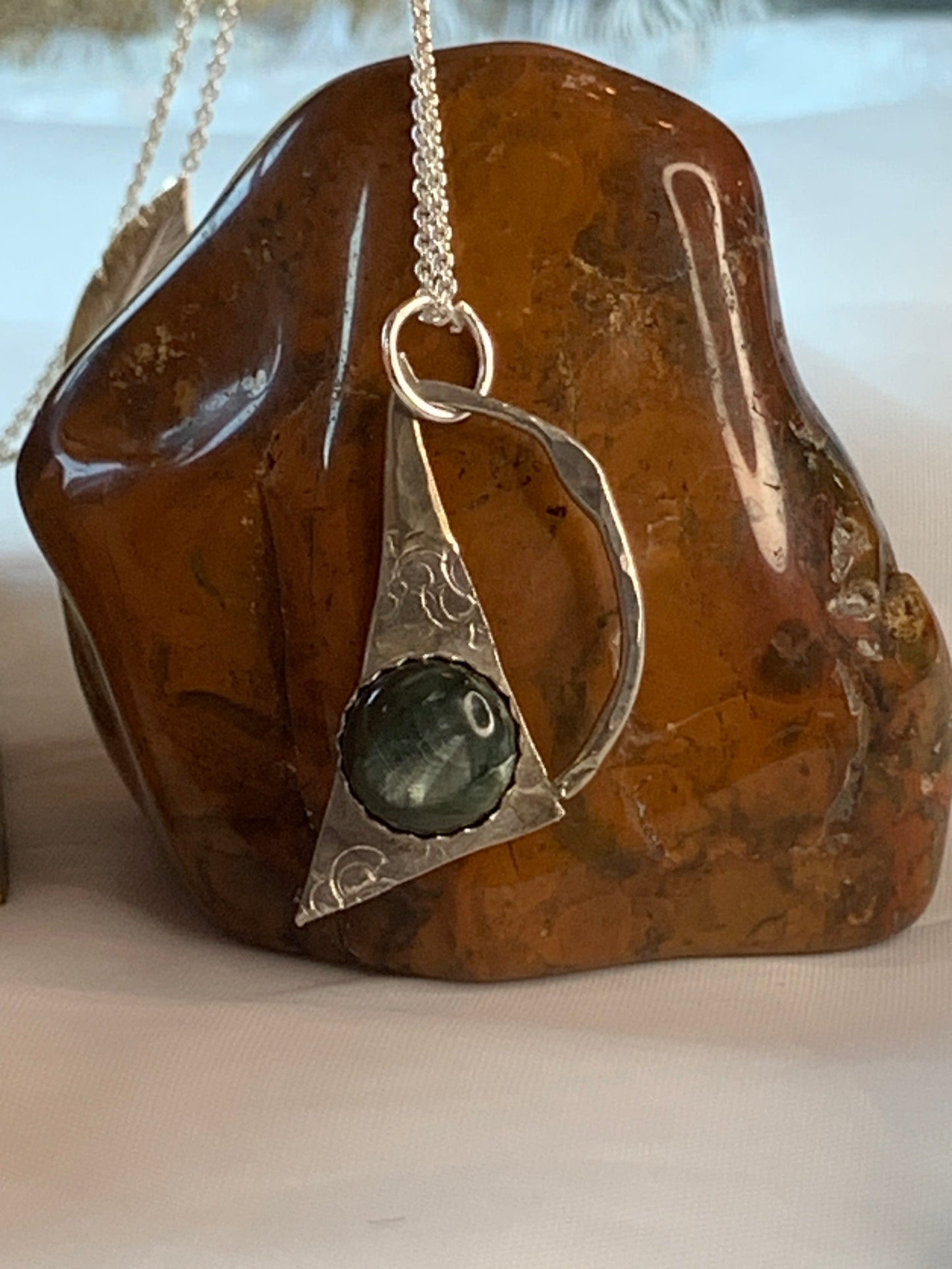 Embrace the fusion of elegance and spirituality with our Geometric Seraphinite Sterling Silver Necklace. It's more than just a piece of jewelry; it's a symbol of authenticity, enlightenment, and the enduring allure of handcrafted craftsmanship. 