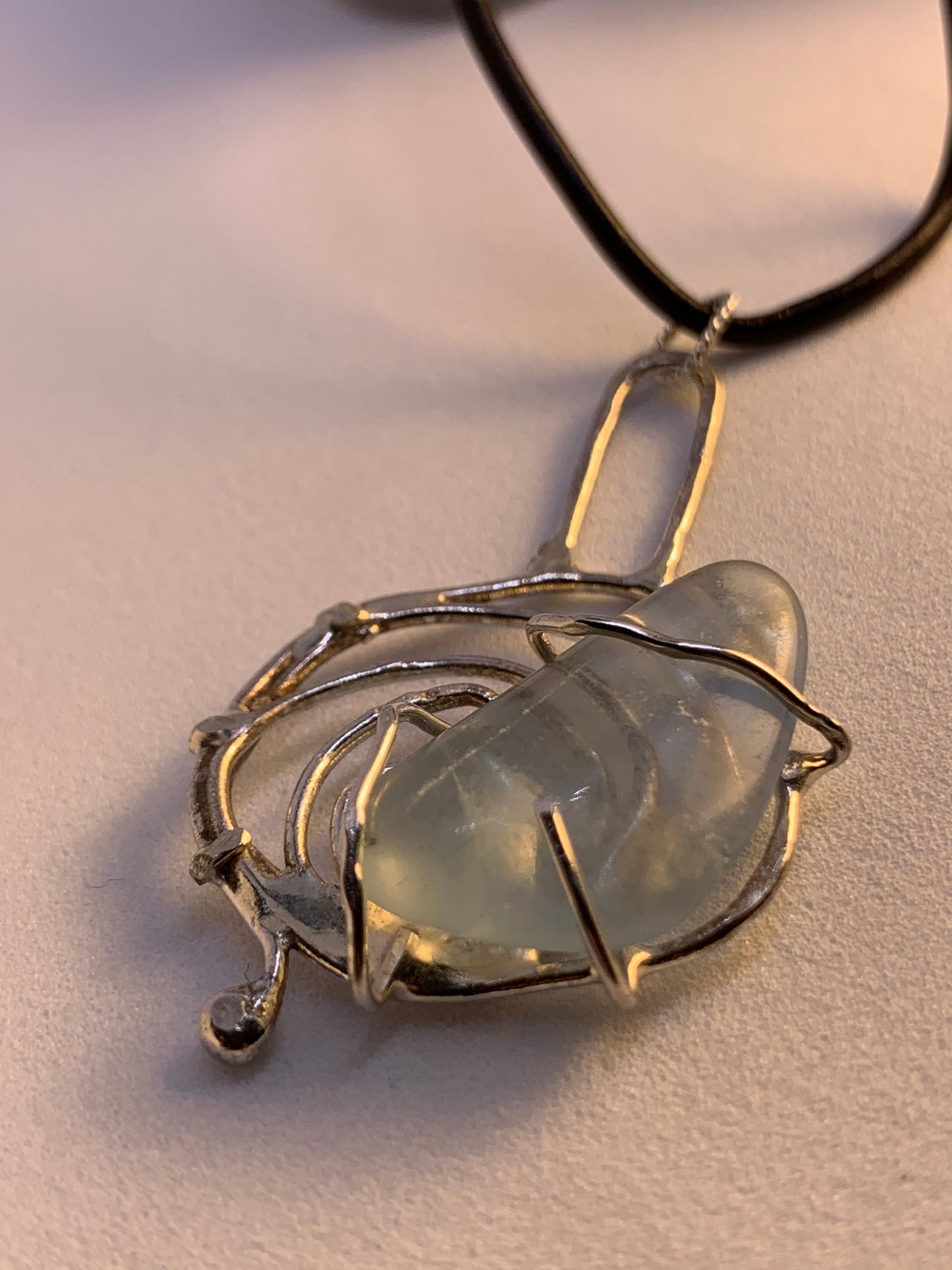 Unique Abstract Fluorite Sterling Silver Pendant. This piece is 3 inches tall and has a natural fluorite stone in center. This stone is soft polished and has the look of sea glass, but its fluorite. 