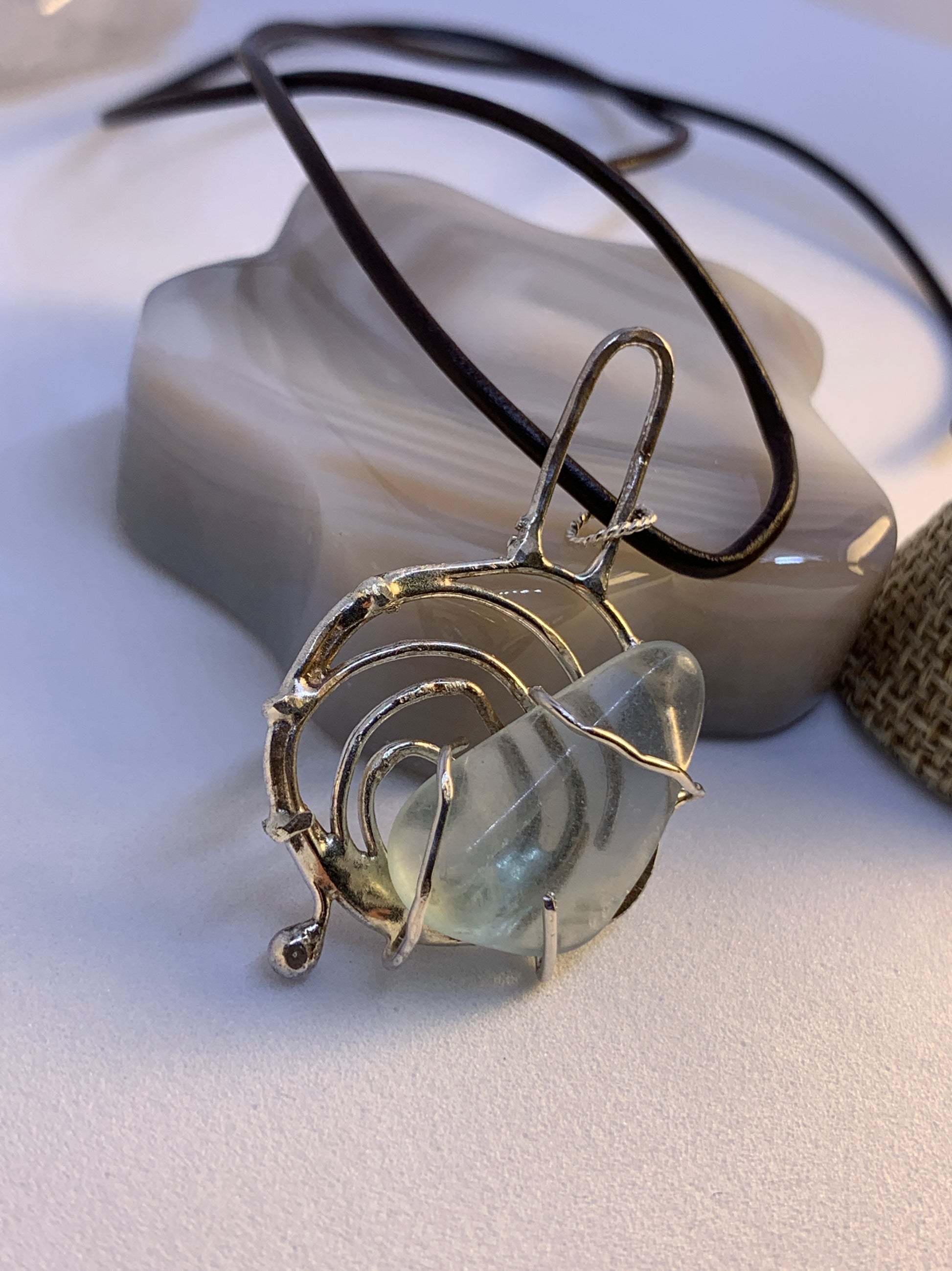 Unique Abstract Fluorite Sterling Silver Pendant. This piece is 3 inches tall and has a natural fluorite stone in center. This stone is soft polished and has the look of sea glass, but its fluorite. 