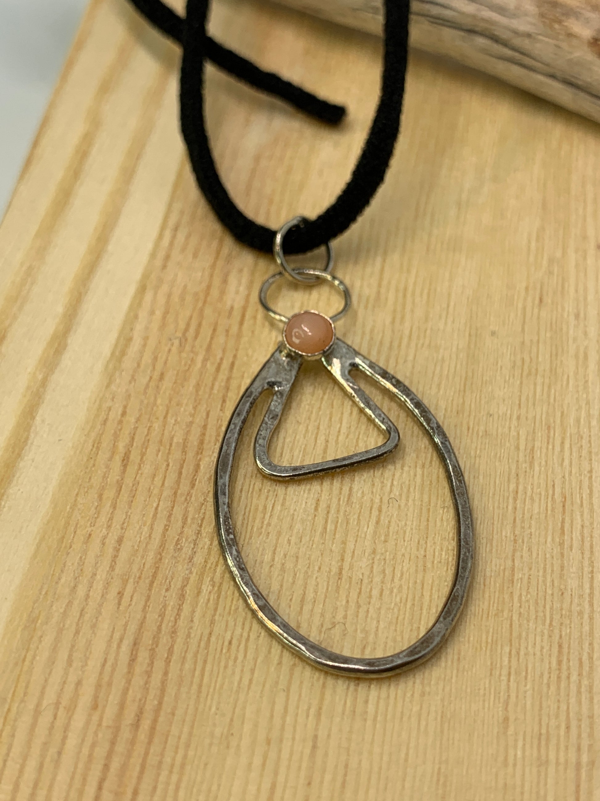 Unique minimalist design with geometric and symbolic tones. Tiny carnelian stone. Made in USA. 