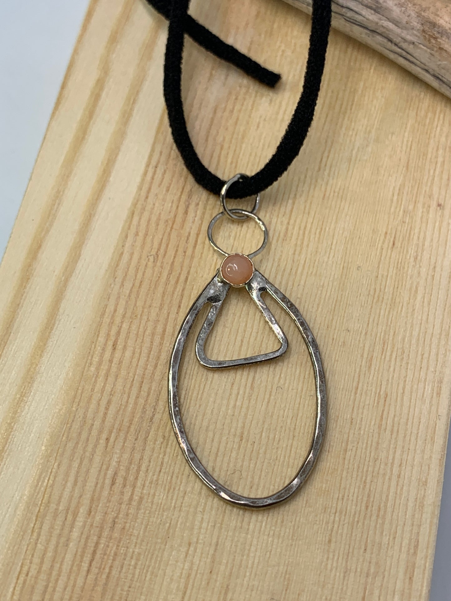 Unique minimalist design with geometric and symbolic tones. Tiny carnelian stone. Made in USA. 